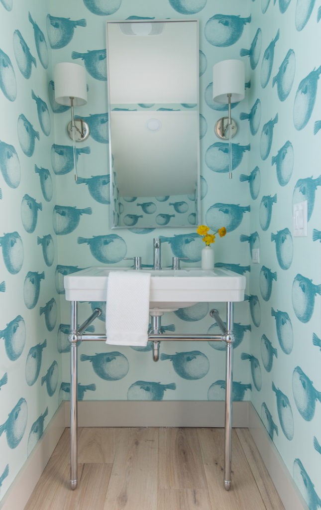 aqua blowfish wallpaper and console sink in bathroom