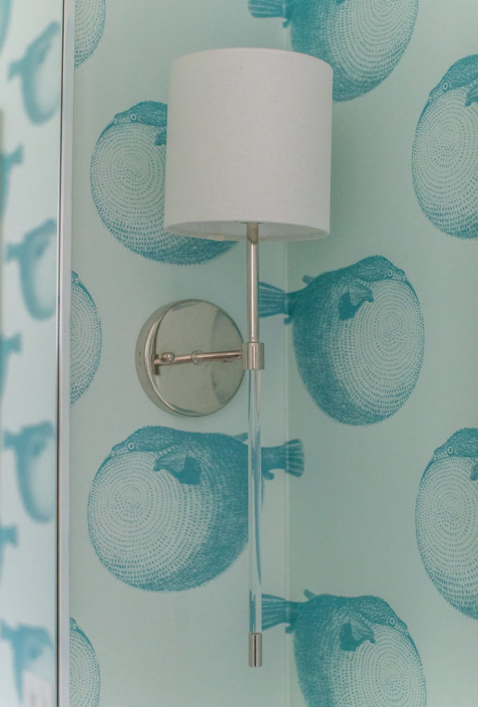 aqua blowfish wallpaper and console sink in bathroom
