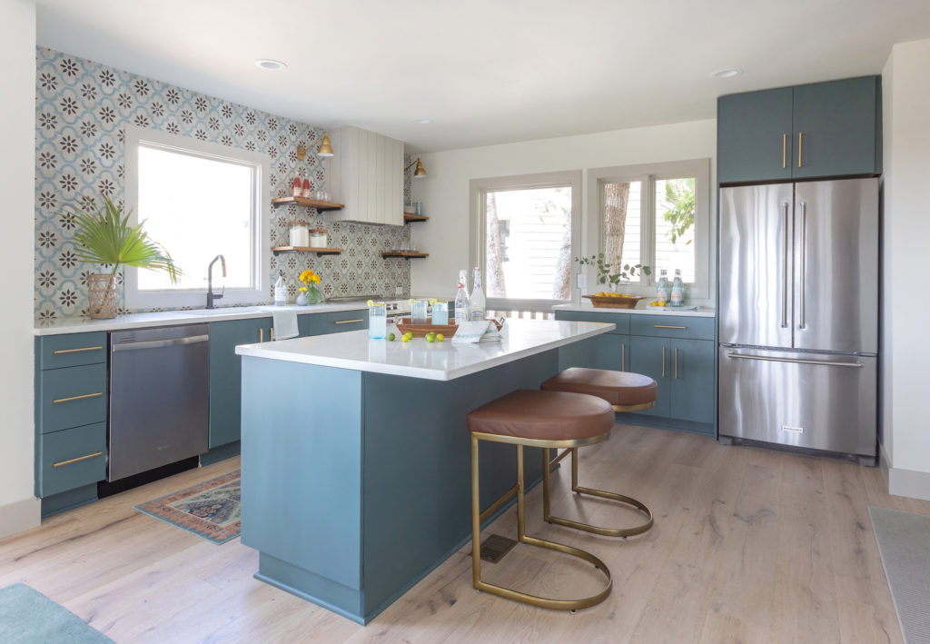 blue green kitchen with open shelving and patterned backsplash