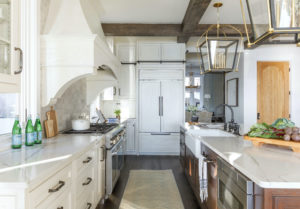 white kitchen with stained island and stained beams