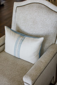 neutral chair with blue pillow
