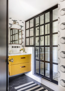 mustard yellow vanity and steel shower doors in bathroom