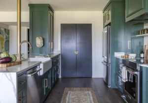 green cabinets and black floor to laundry room