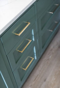 green kitchen cabinets with brass hardware