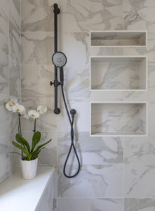 floating vanity and marble look tile in bathroom